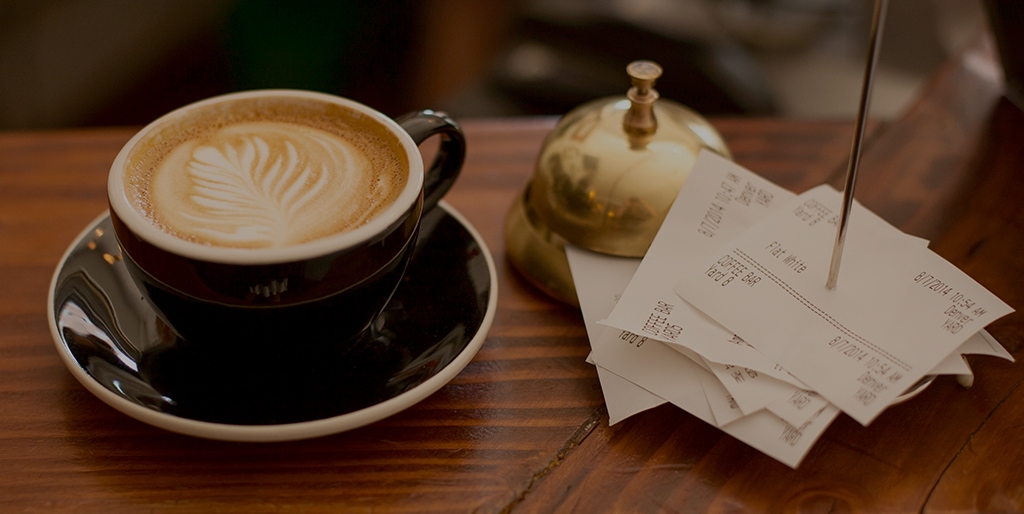 a cup of coffee and receipts